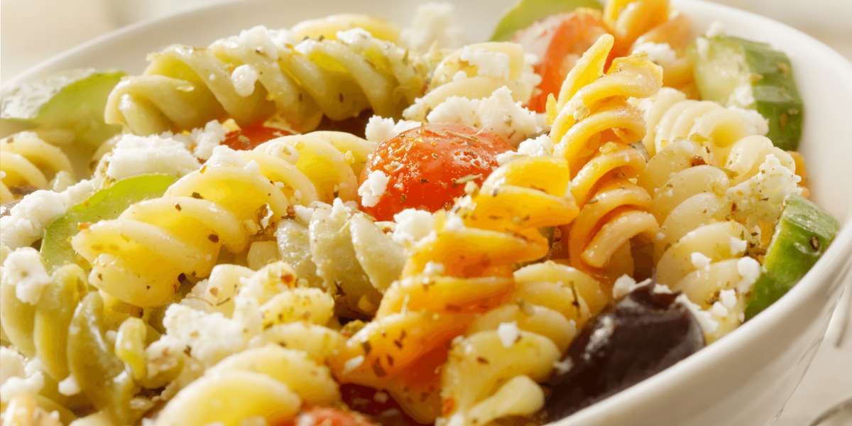 Spiral pasta with feta cheese and cucumbers and tomatoes