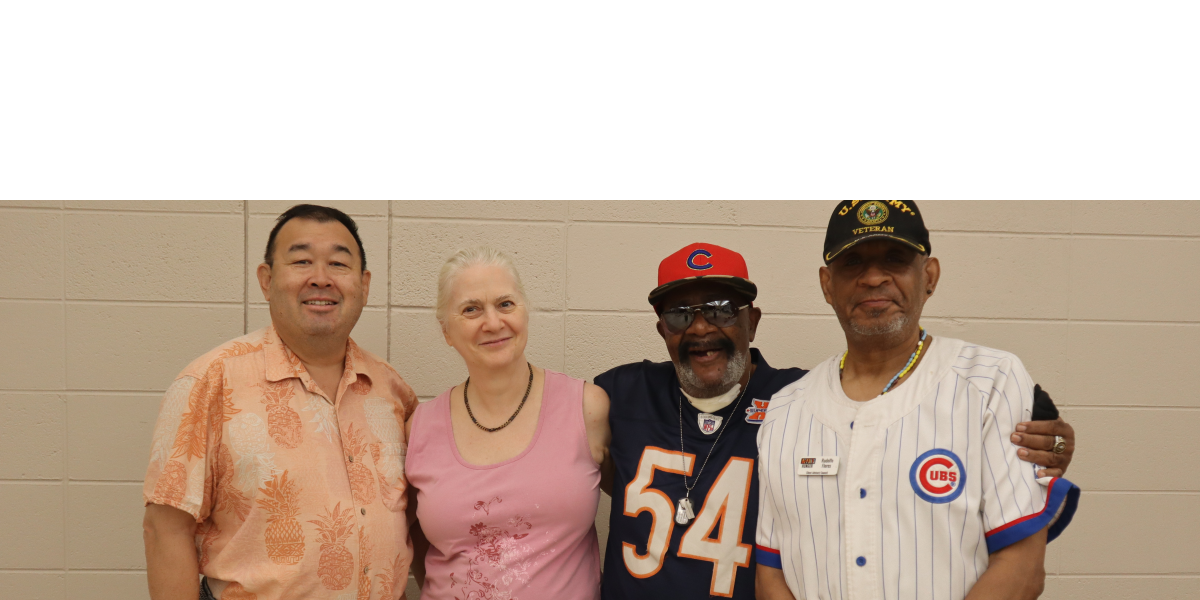 4 members of the Beyond Hunger Client Advisory Council standing side-by-side and smiling.