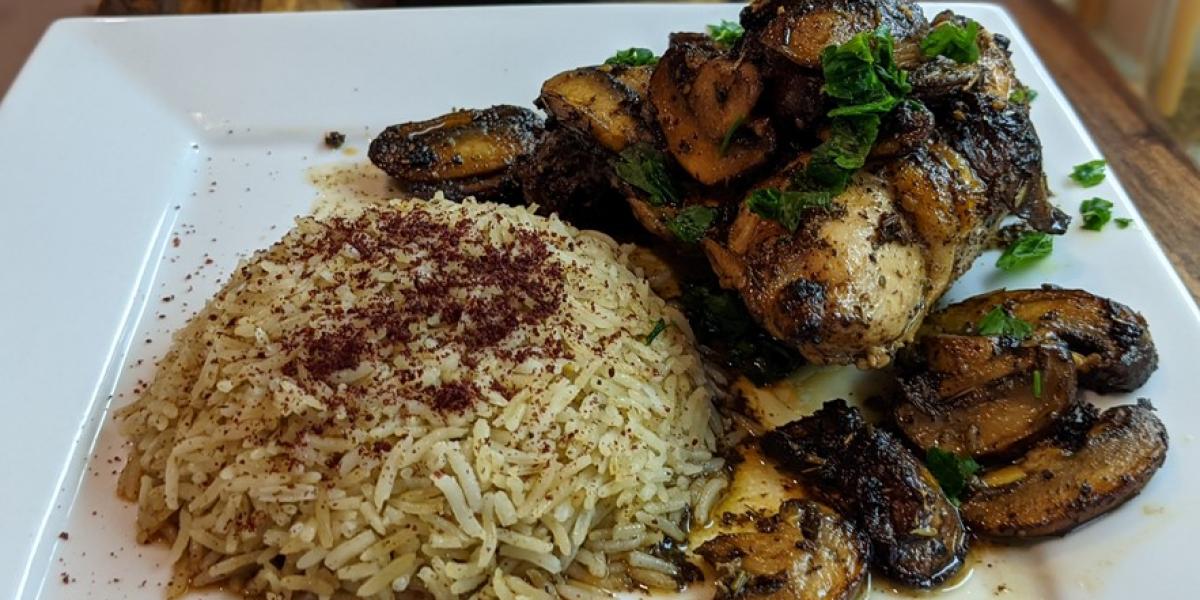 Lemon Herb Chicken with mushrooms and rice on white plate