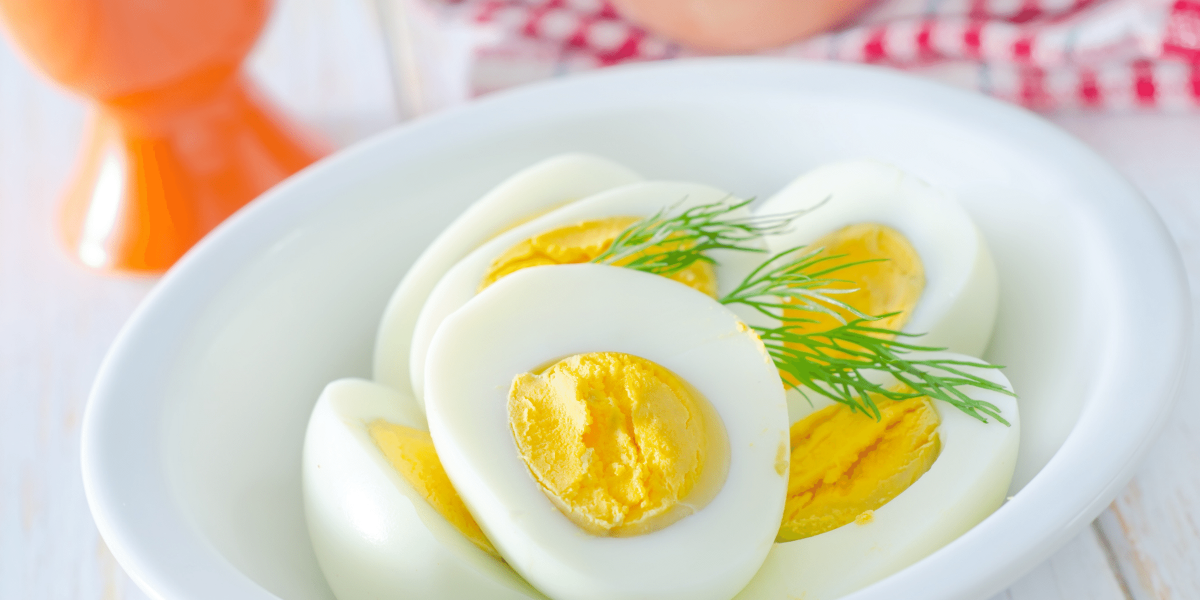 Hard boiled eggs cut in half in white bowl